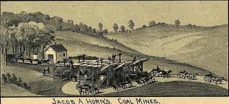 A small drawing of a wooden coal tipple and loading chutes on a grassy hillside, with horse-drawn wagons lined up on a road to haul coal away.